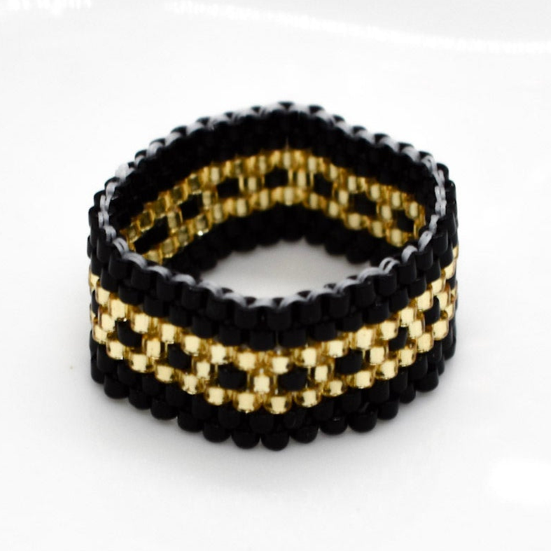 Black and gold beaded bracelet on a white background