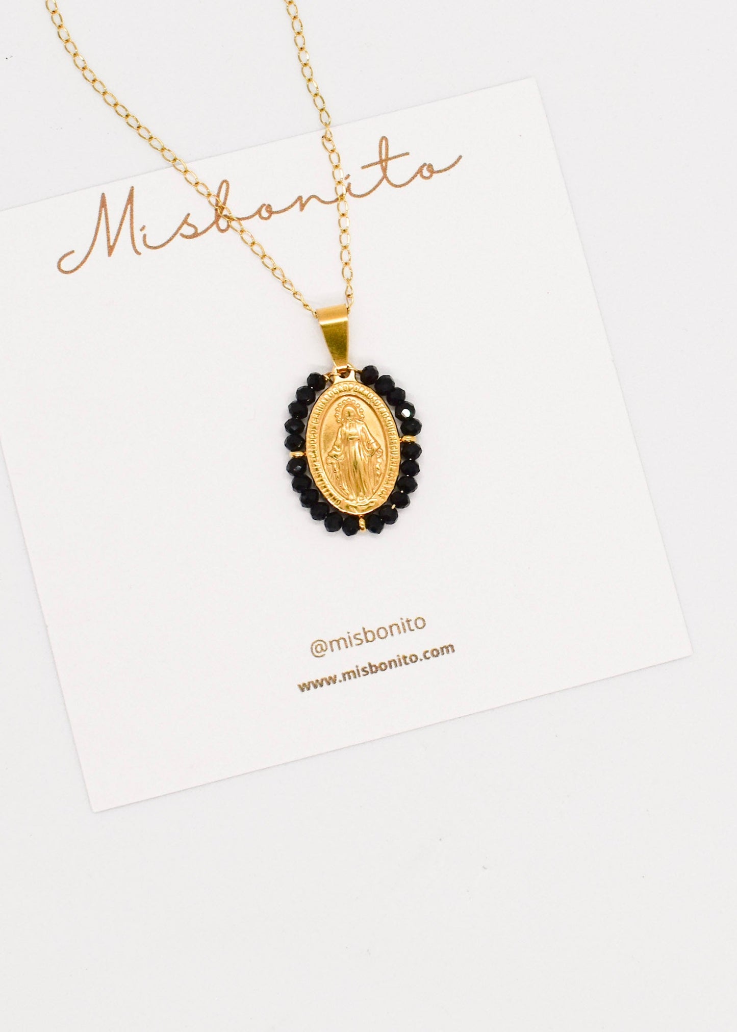 Black crystals virgin pendant necklace on a card