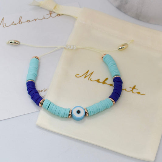 Bracelet with blue heishi beads on a 'Misbonito' branded pouch