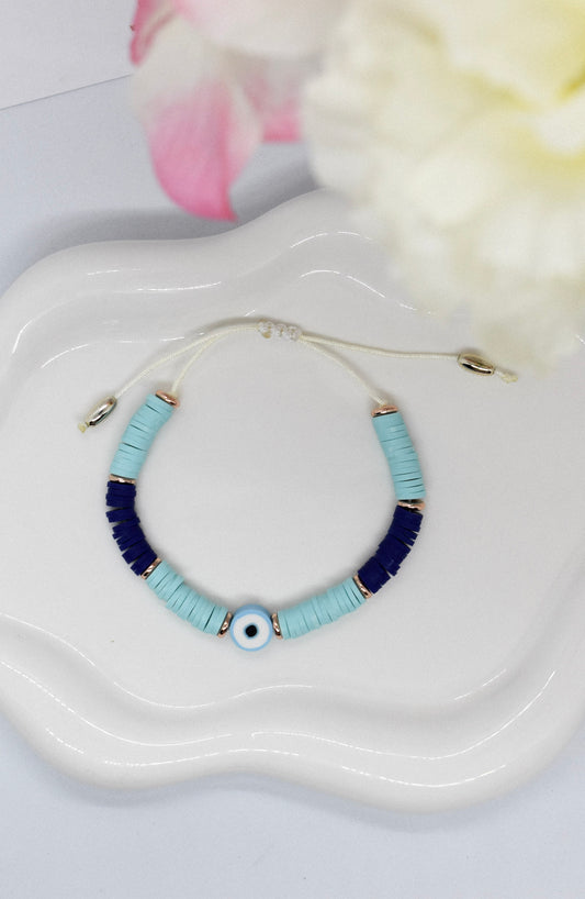 Bracelet with blue polymer clay beads on a 'Misbonito' branded pouch