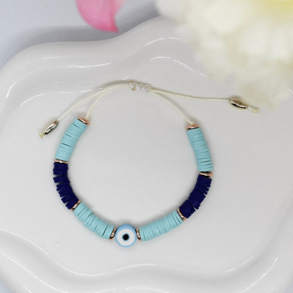 Bracelet with blue polymer clay beads on a 'Misbonito' branded pouch