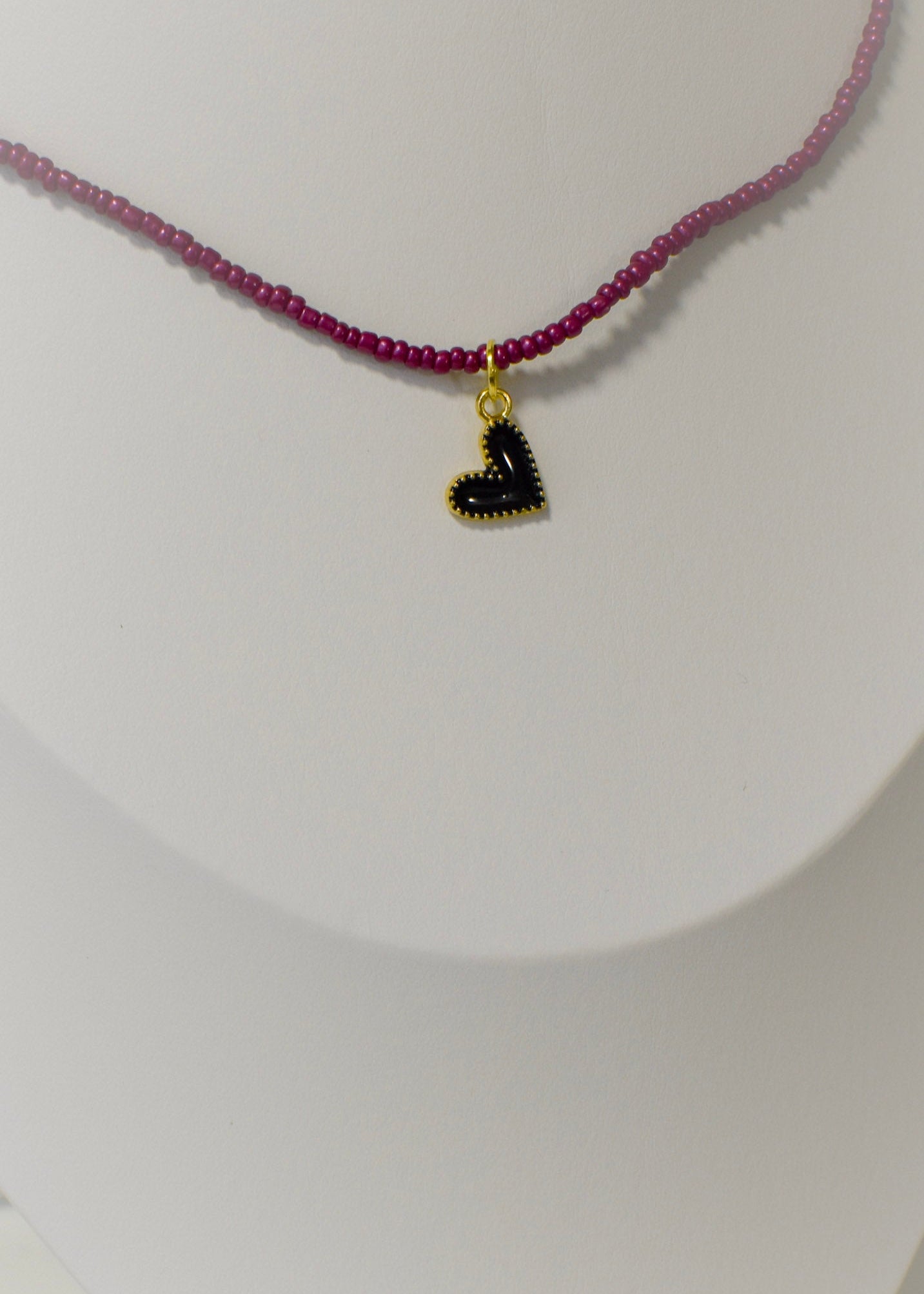 Burgundy beaded necklace with a black heart tiny pendant