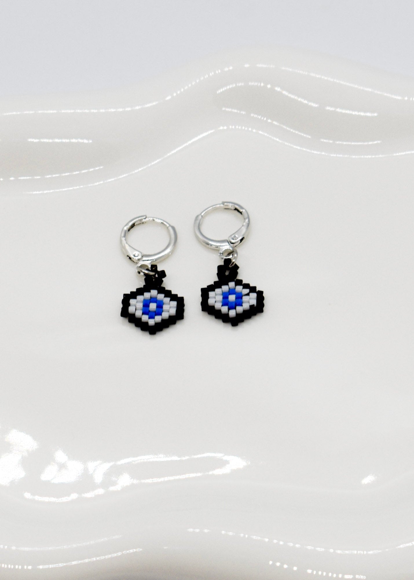 Evi ele hoops with hexagonal designs on a white background