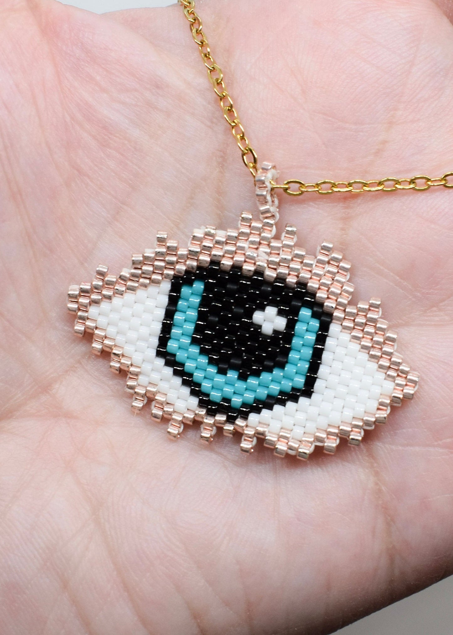 Evil eye beaded necklace on hand