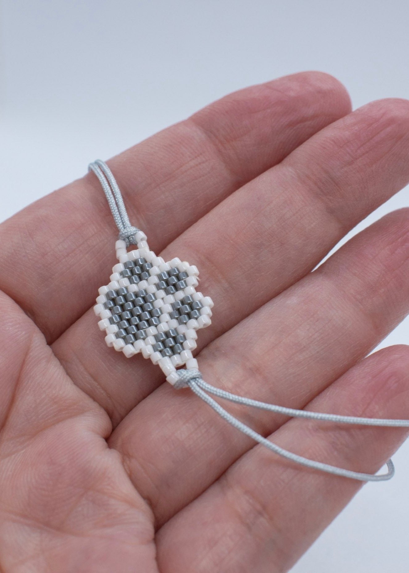 Miyuki grey paw bracelet