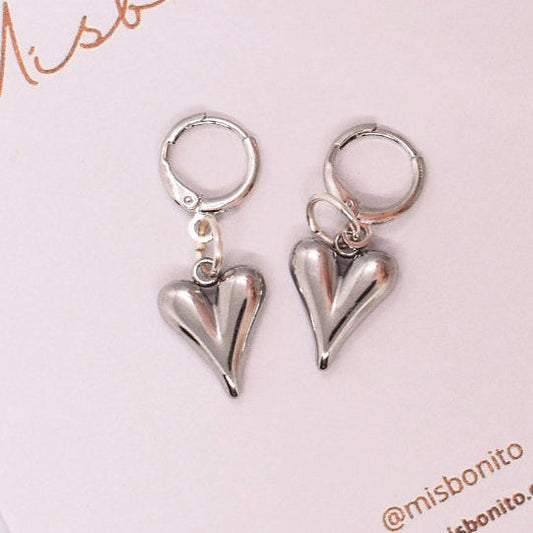 Silver heart-shaped earrings on a Misbonito branded card with floral background