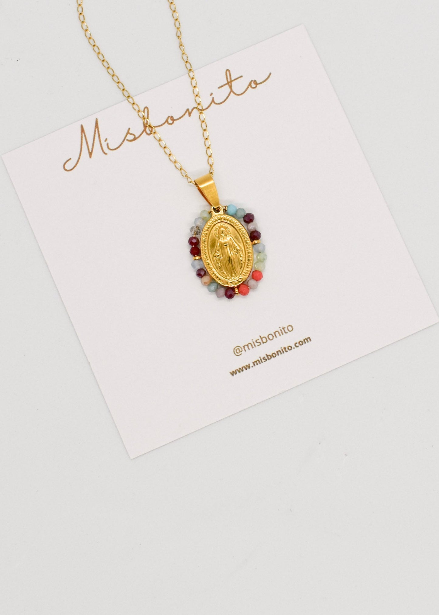 Virgin necklace with colorful crystals on a white background