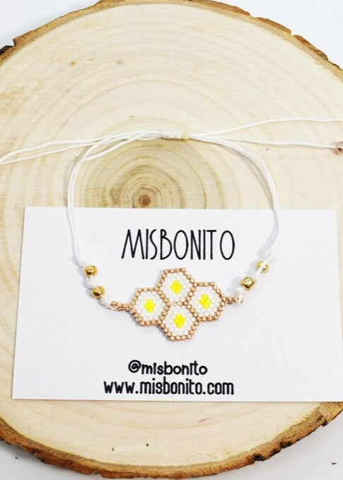 bee hive bracelet on a wood slice