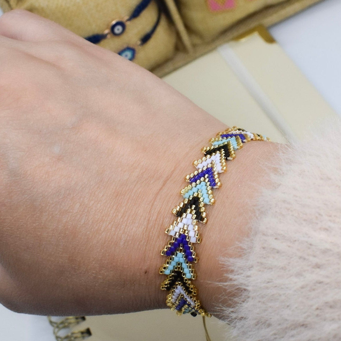 blue arrow bracelet with a jewelry box in the background