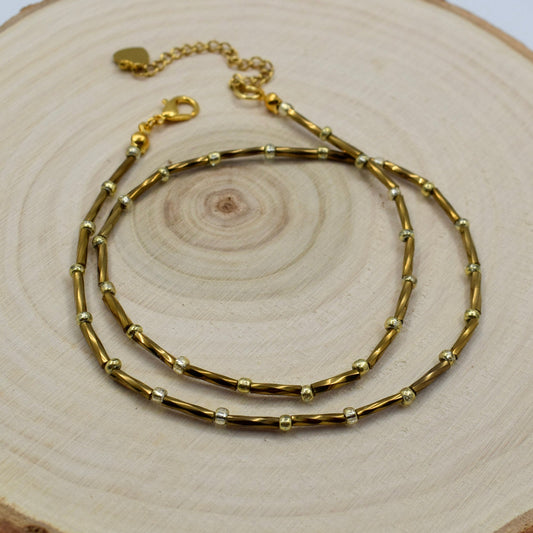 bronze tube necklace on a display