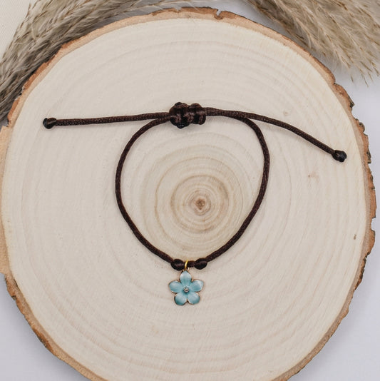 brown and blue floral satin bracelet on a wood surface