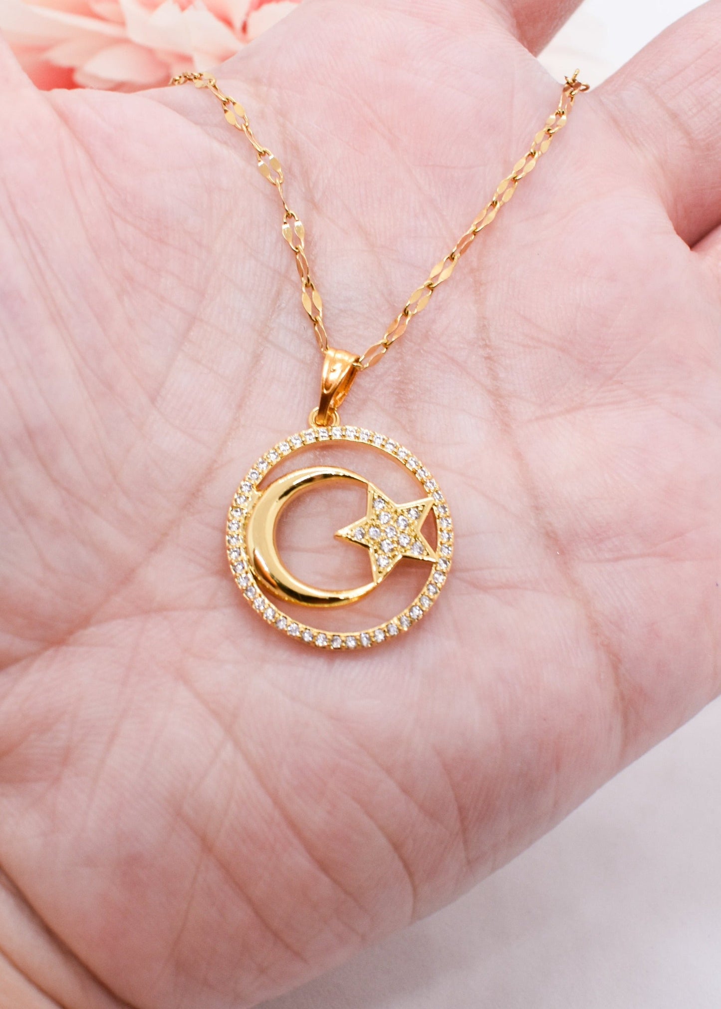 moon necklac on hand