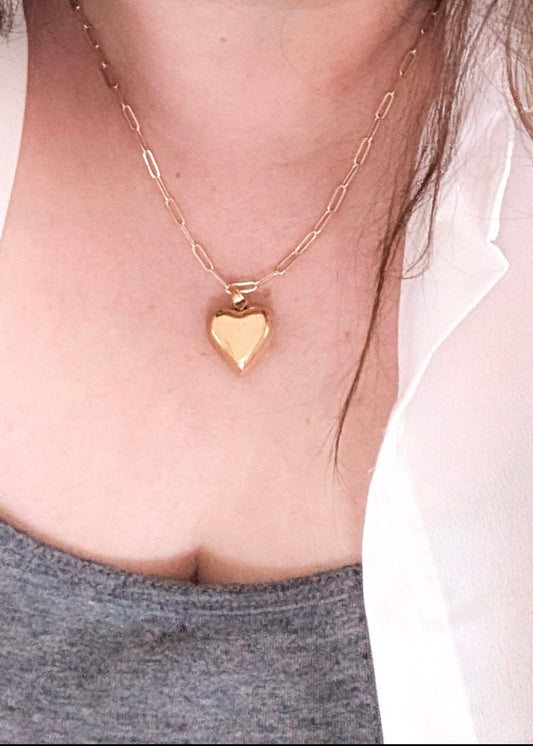 chunky heart necklace on a woman's neck