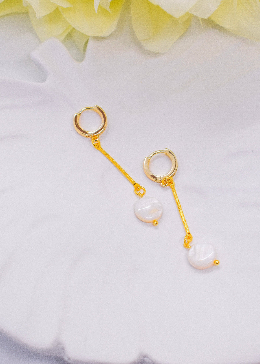 flat pearl earrings on a tray