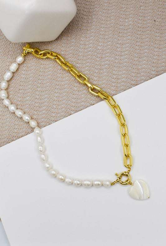 full photo of a pearl and chain heart necklace on a white background