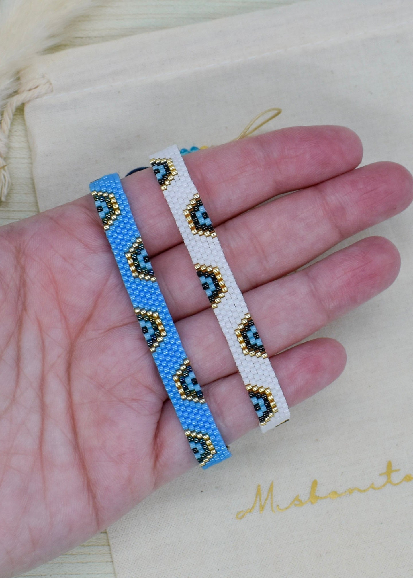 evi leye two blue bracelets on hand