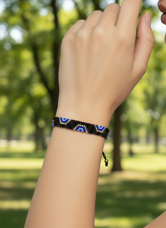 AI model arm wearing a Beaded headband with blue and gold accents on a mannequin head.