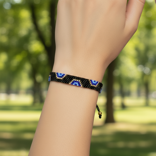 AI model arm wearing a Beaded headband with blue and gold accents on a mannequin head.