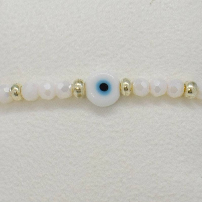 Bracelet with a central evil eye bead surrounded by smaller beads on a white background