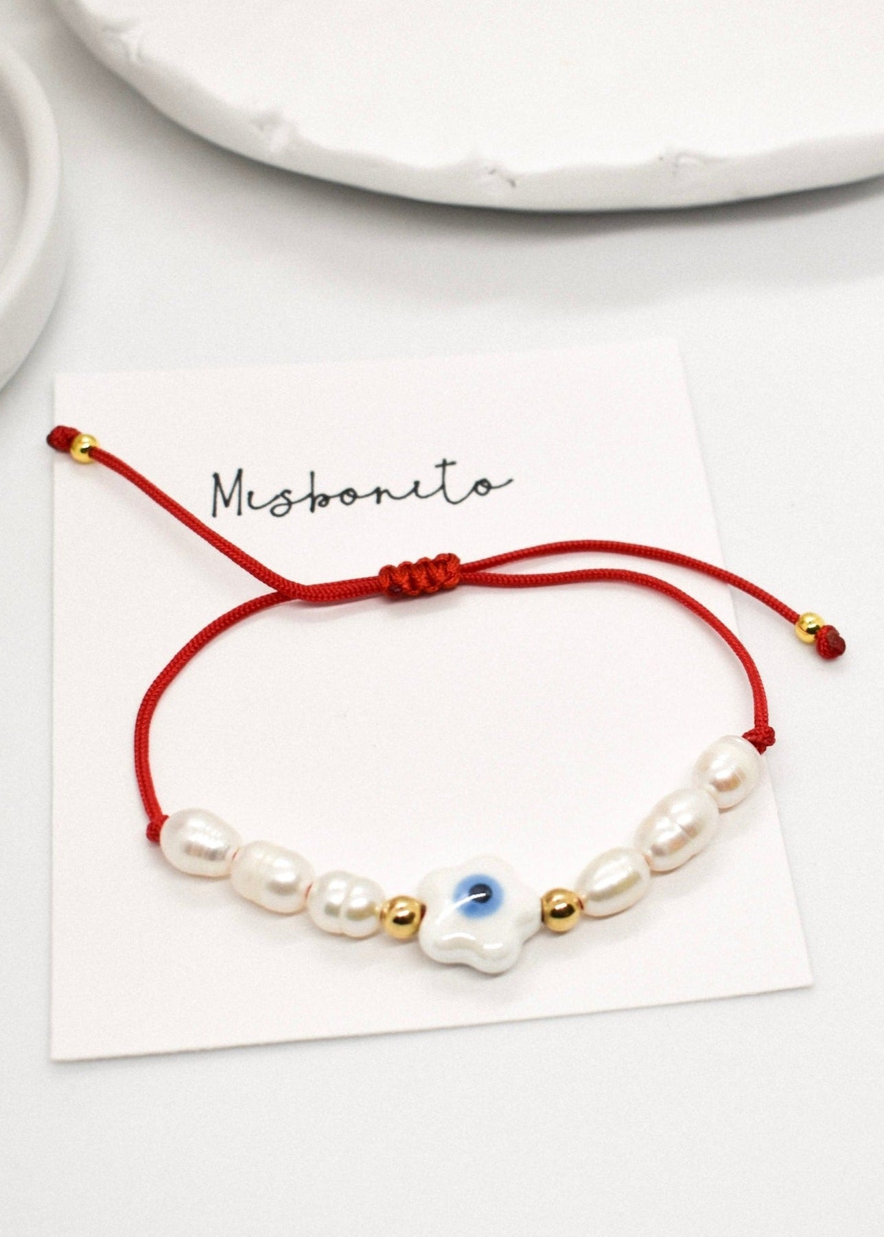Evil eye pearl bracelet on a card