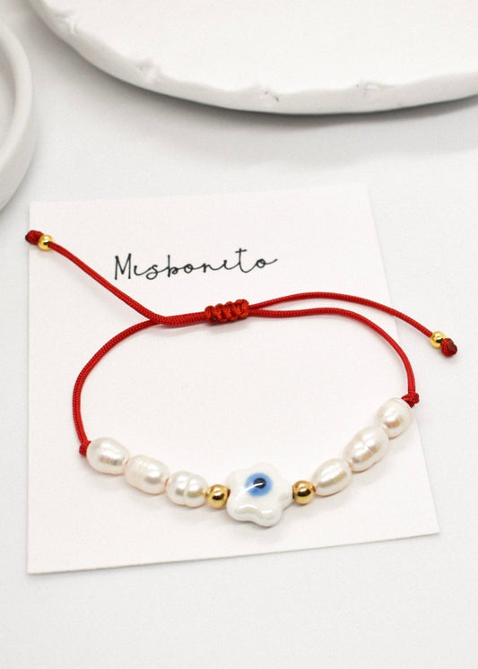Evil eye pearl bracelet on a card