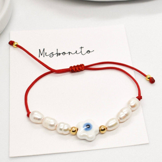 Evil eye pearl bracelet on a card
