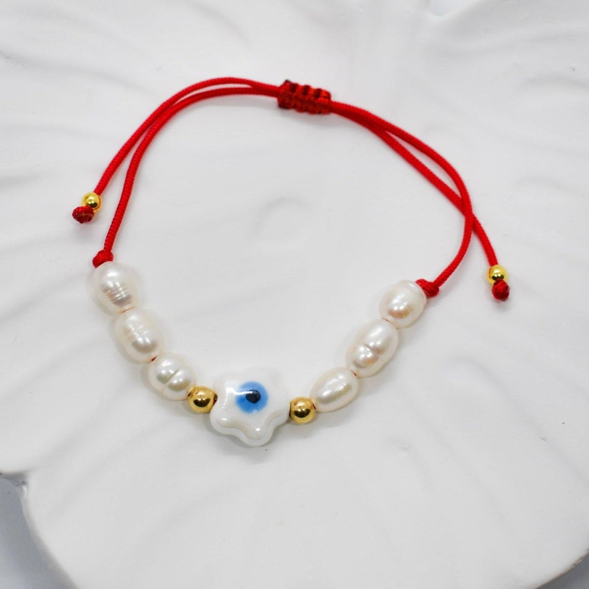 Evil eye pearl bracelet on a tray