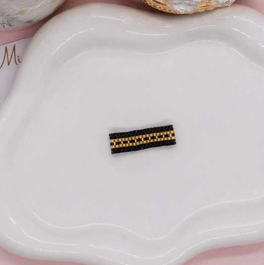 golden and black ring