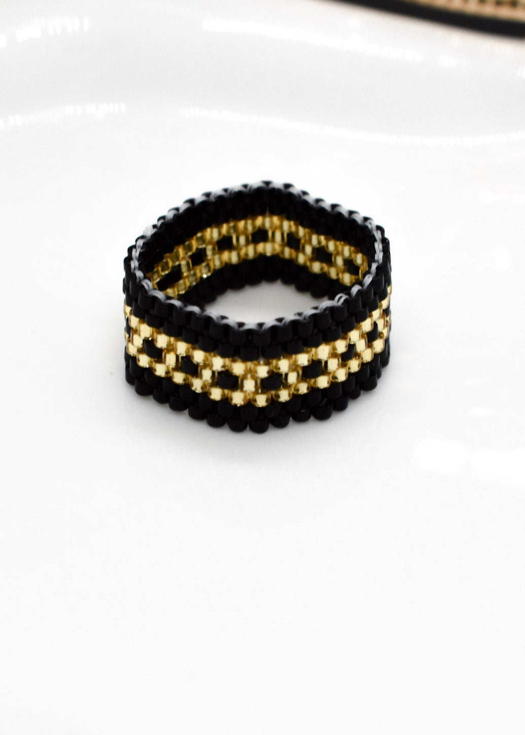 golden and black ring beaded
