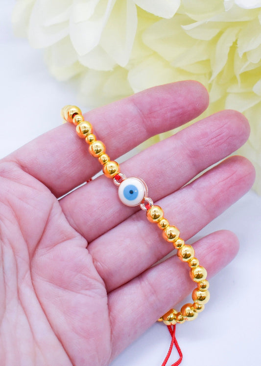 evil eye golden bracelet on hand
