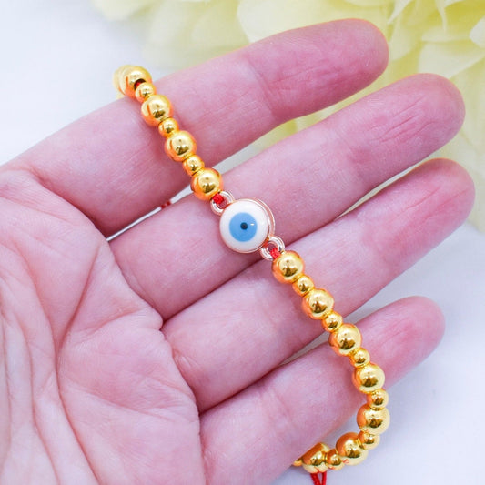 evil eye golden bracelet on hand