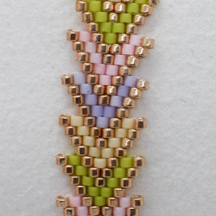 Beaded bracelet with a chevron pattern on a white cushion