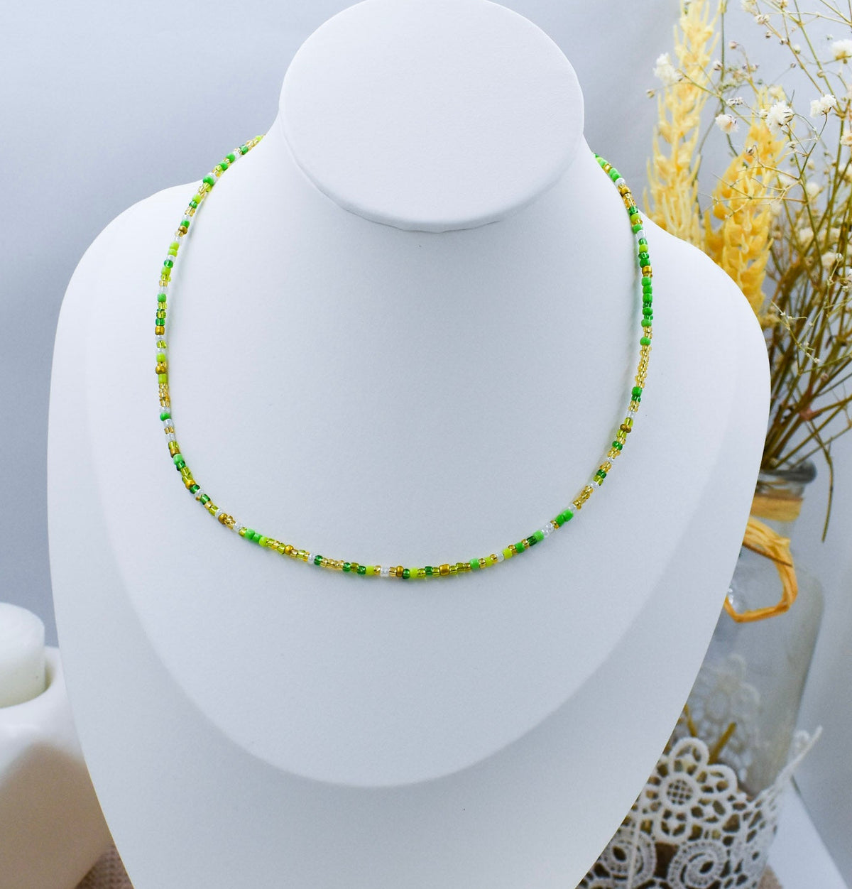green beads necklace on a bust
