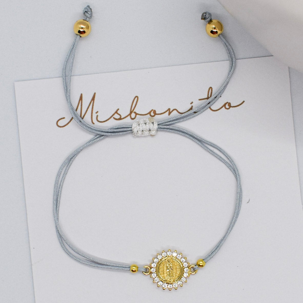 Bracelet with decorative clasp on a white card with 'Misbonito' branding.