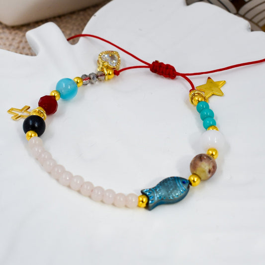 Colorful beaded bracelet with various beads on a white surface