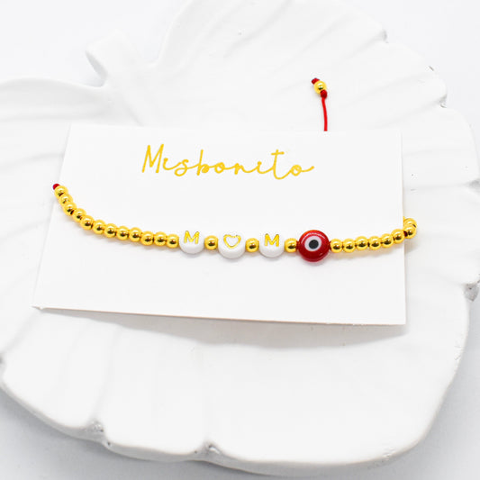 mom evil eye bracelet on a tray