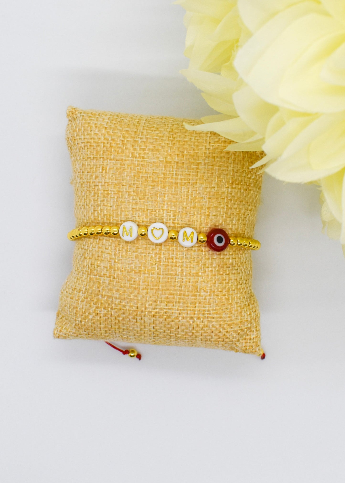 mom bracelet on a pillow