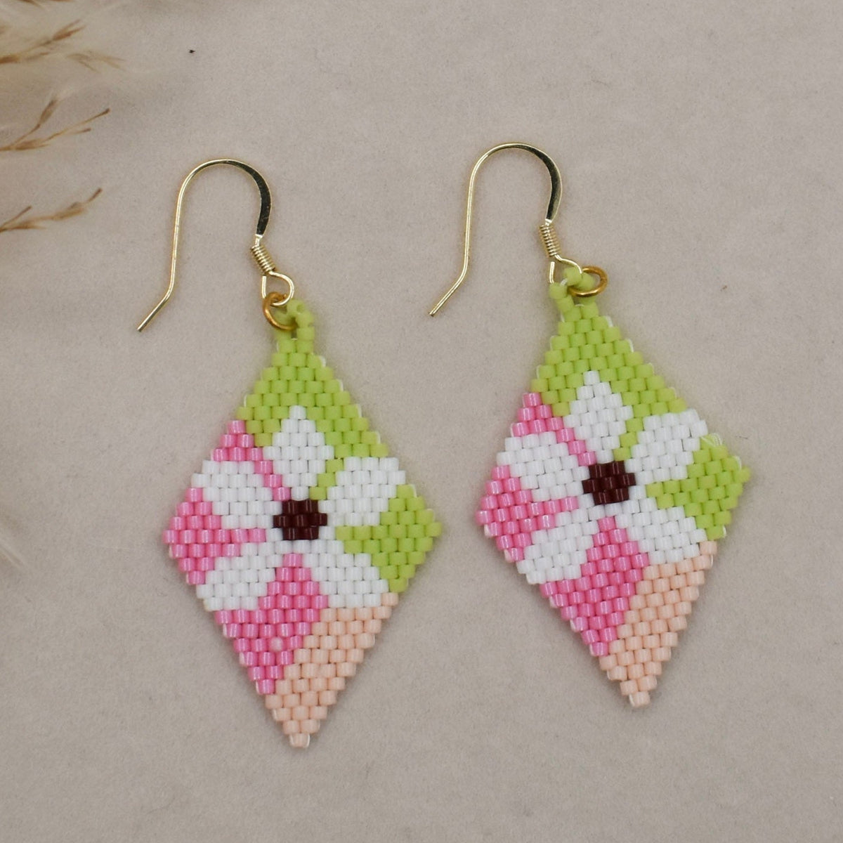 pink beaded earrings on beige background