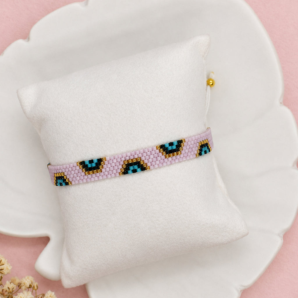 Beaded headband on a pillow with a white background