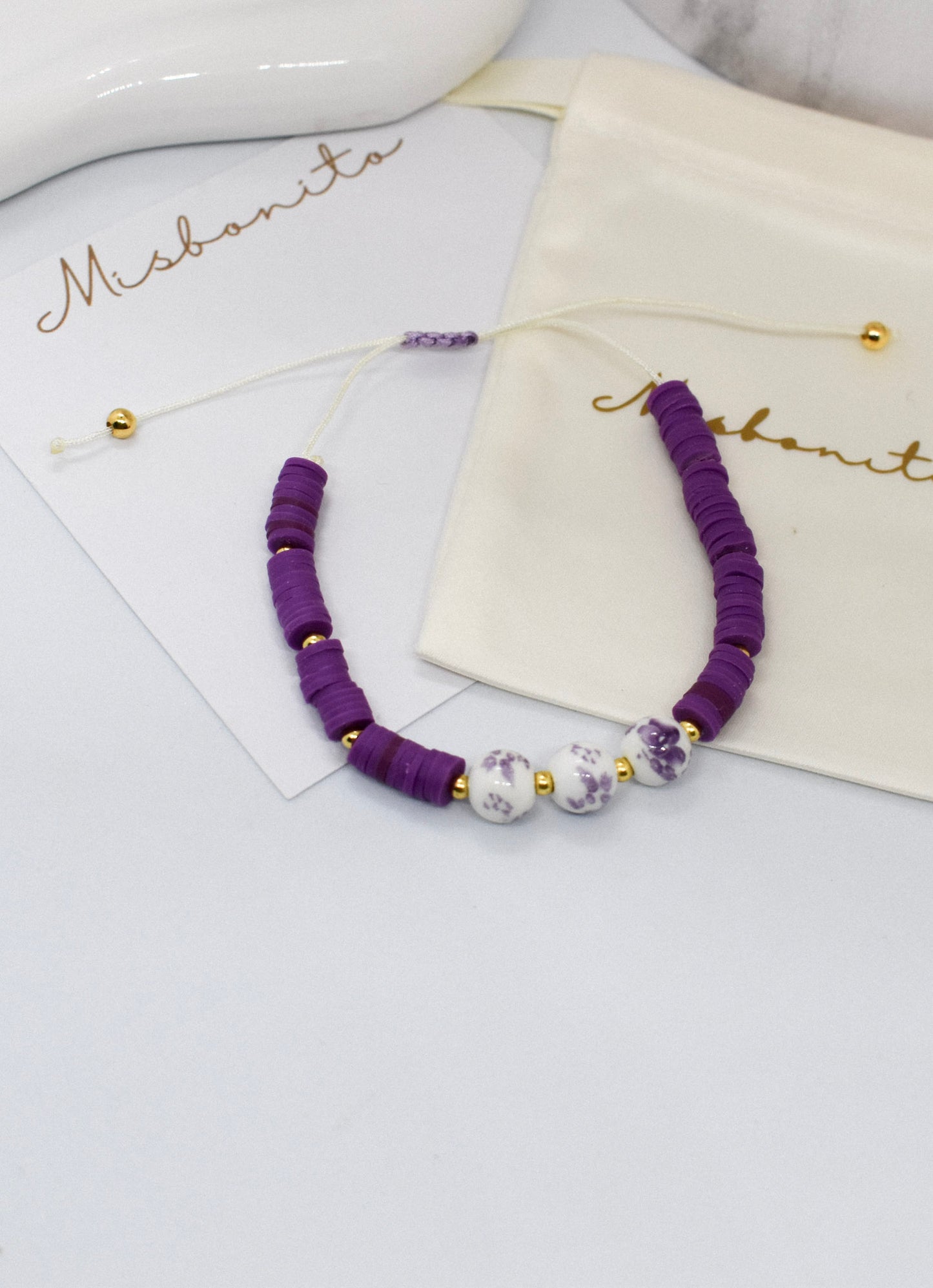 purple heishi bead with 3 beads on a misbonito branded card