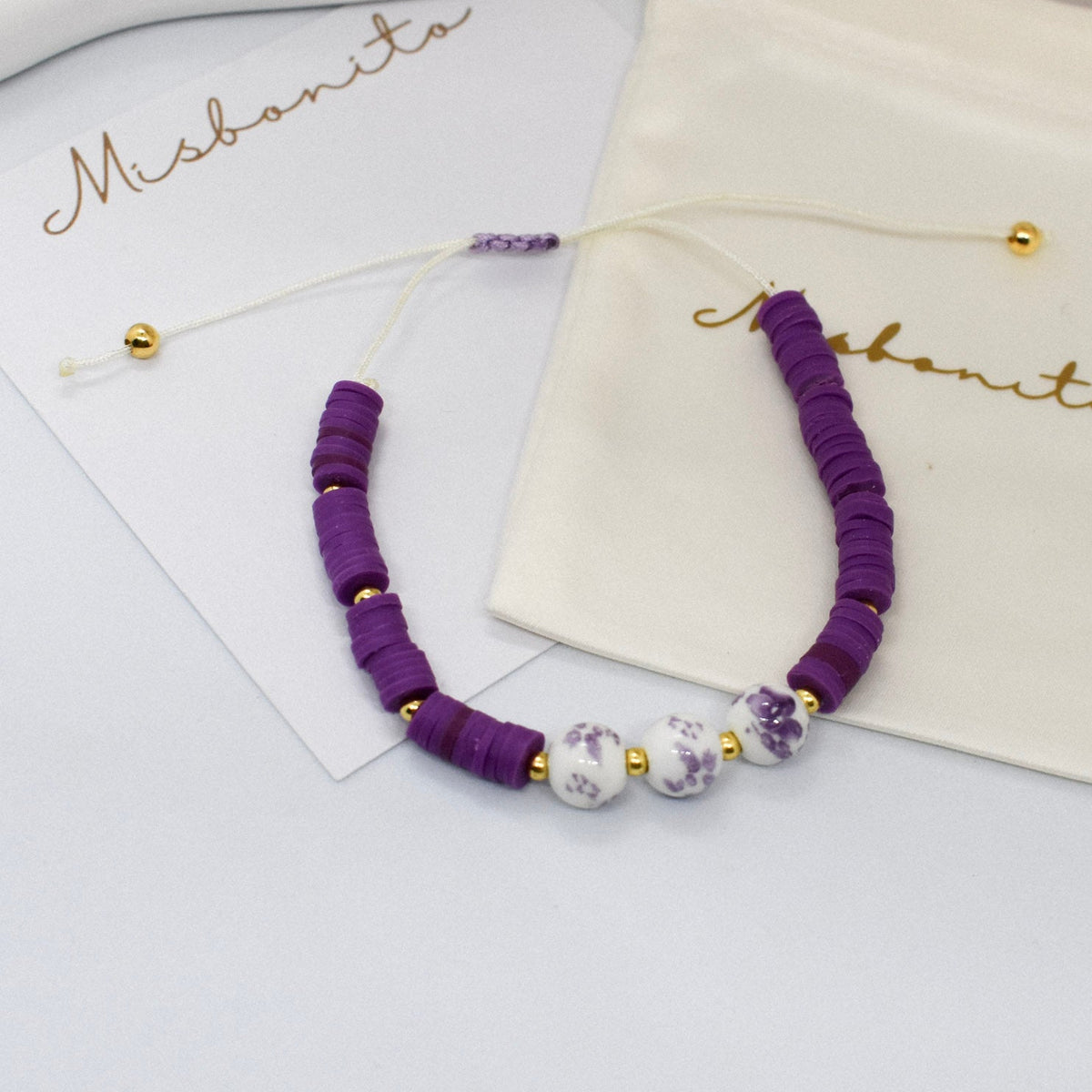 purple heishi bead with 3 beads on a misbonito branded card