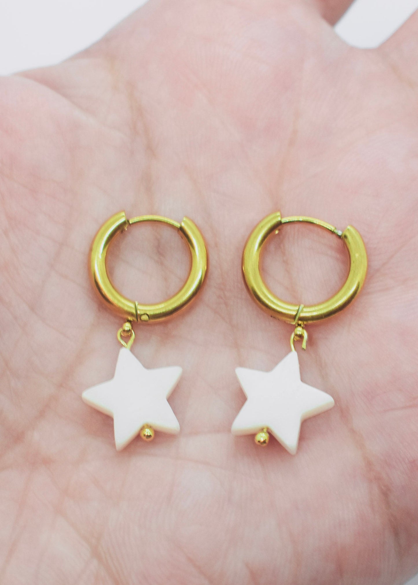 star hoop earrings on hand