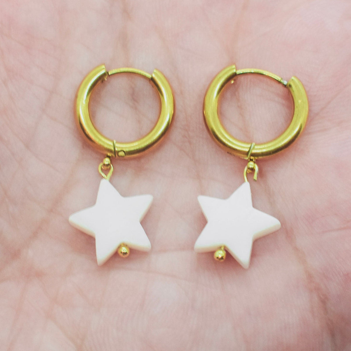 star hoop earrings on hand