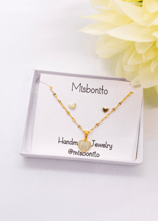 tiny heart necklace set on a box