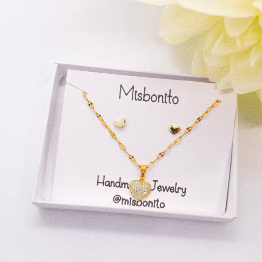 tiny heart necklace set on a box