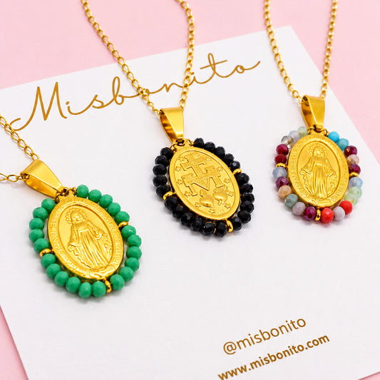 Three gold necklaces with colorful virgin mary pendants on a white card with 'misbonito' branding.