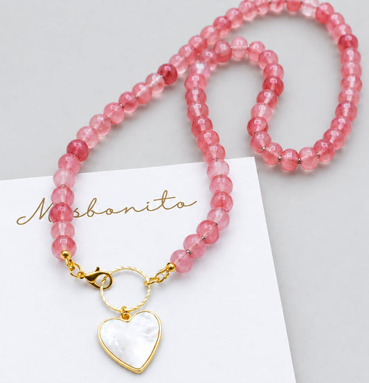 watermelon natural stone necklace with a mother pearl heart on a misbonito card