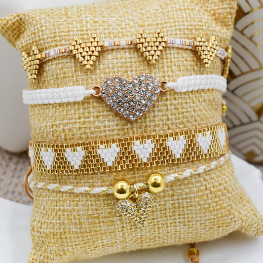 Set of bracelets on a decorative pillow with a heart charm