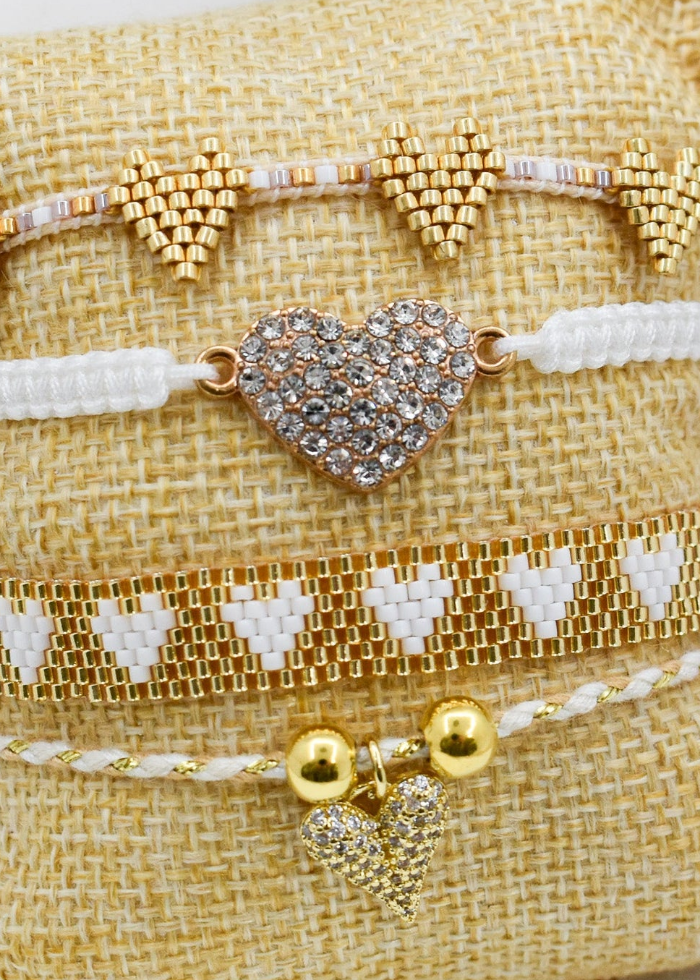 zoomed white_heart_bracelets_set on a pillow