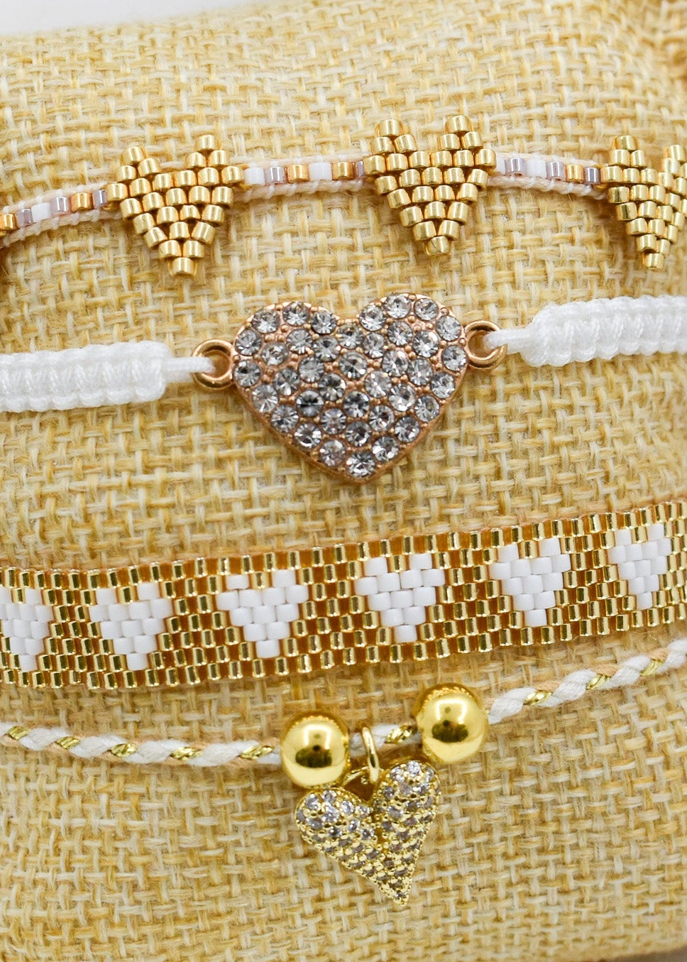 zoomed white_heart_bracelets_set on a pillow